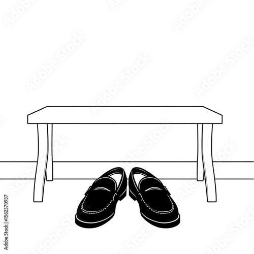 A pair of loafers under a hall bench
