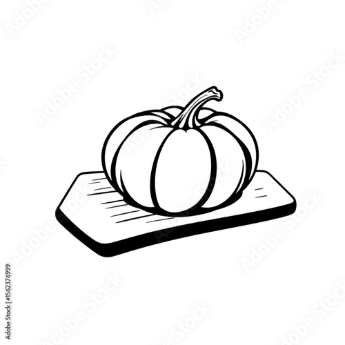 A single pumpkin seed on a chopping board