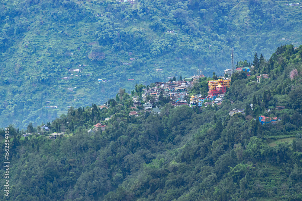 Fototapeta premium Scenic beauty of Green forests of Himalayan mountains, Okhrey, sikkim, India. Okhrey village is remote place in Sikkim where peaceful, tranquil Himalayan mountain range is enjoyed by tourists.