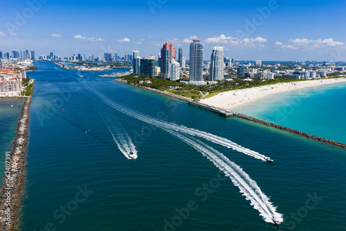 Yacht cruising near Miami Beach. Aerial view of boats on turquoise waters in Miami. Yacht retreat in South Florida Miami.