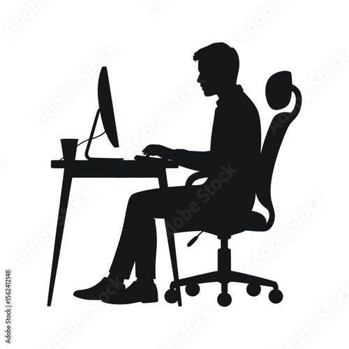 Silhouette of a person working at a computer desk