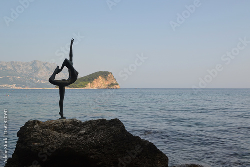 Iconic Ballerina Statue in Budva, Montenegro, with the Historic Old Town, Its Bell Tower, and Majestic Mountains Creating a Stunning Coastal Backdrop