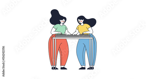Two women working together at a table in colorful clothing  