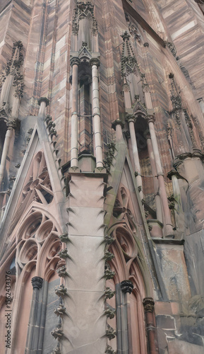 Pink sandstone details and columns decorating the facade of Strasbourg Cathedral in France, a masterpiece of Gothic architecture