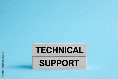 Wooden blocks stacked with the words technical support clearly printed in black text against a solid light blue background