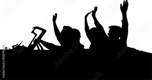 People raising hands in celebration crowd raised