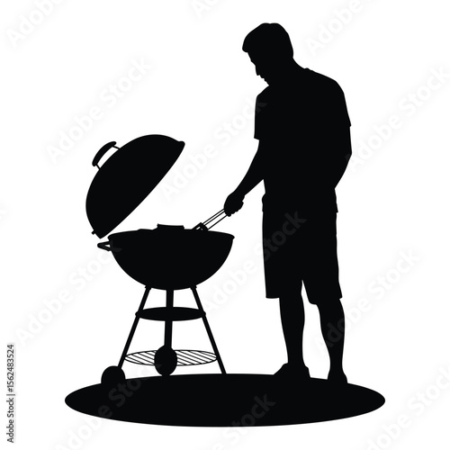Man grilling food on a charcoal barbecue grill silhouette