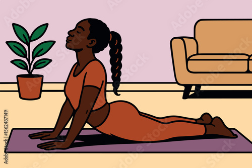 A black woman practices yoga in a cozy inner environment, showing flexibility and well -being - bhujangasana yoga position