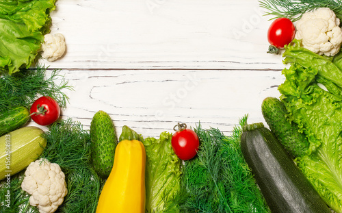 Healthy food. Vegetables and greens. On a white wooden background.