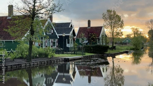 traditional Dutch small town scenery in Zaanse Schans over water at summer sunset, Netherlands