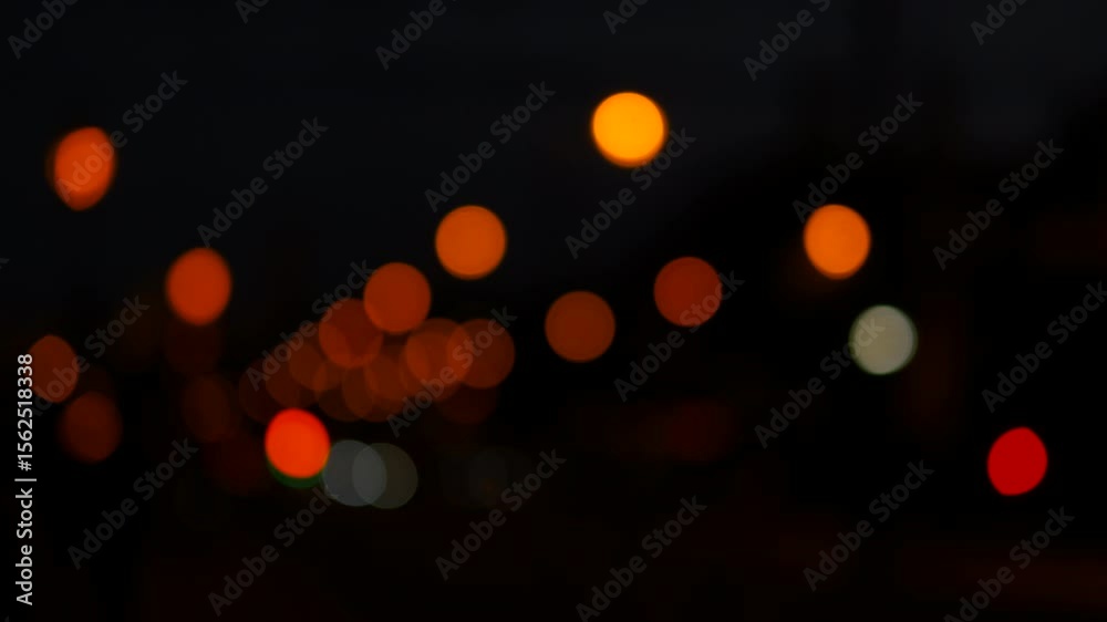 City lights blurring while cars are moving at night. Blurred city lights transform at night as cars navigate a bustling street. Vibrant colors create an abstract backdrop of urban energy and motion
