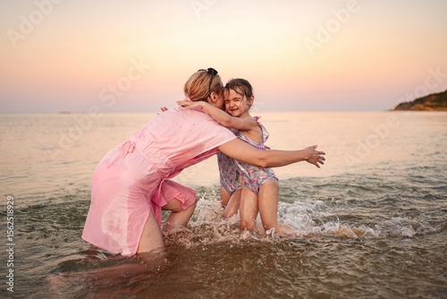 Joyful family moments at the beach during sunset
