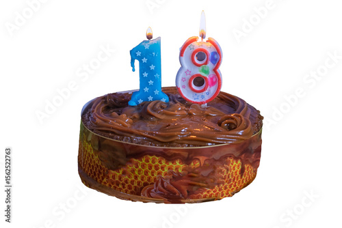 Birthday chocolate cake with a candle in the shape of the number 18 isolate on a white background.
