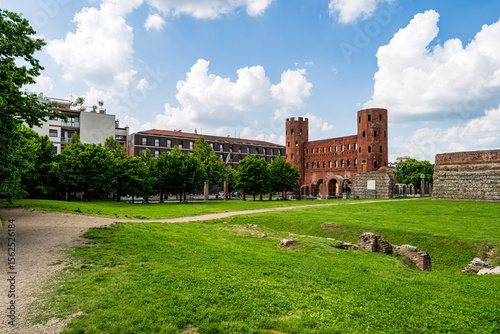 Historic Ruins Enthusiastically Surrounded by Lush Greenery and Modern Urban Architecture