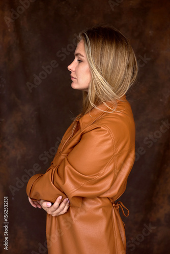 Profile of young woman wearing leather shirt photo
