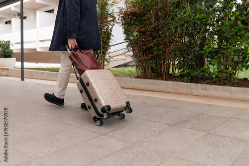 Businessman walking with suitcase and bag