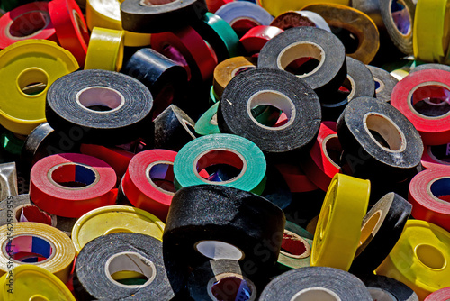 Large pile of colorful insulated tapes sold outside on flea market stall