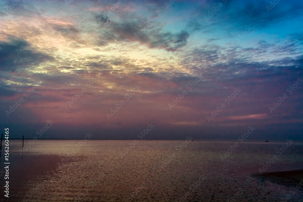 Fototapeta premium Sea beach with sky sunset or sunrise. Clouds over the sunset sea.