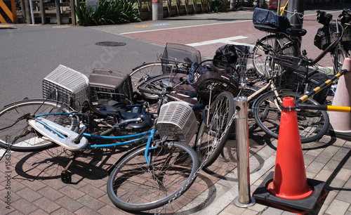 Bicycles parked haphazardly in a busy urban area 