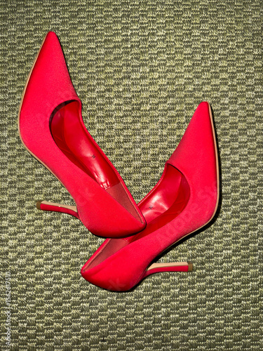 Red high heel shoes on carpet
