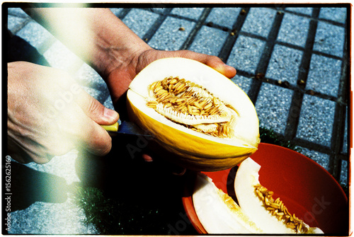 man cutting a slice of melon, 35mm film