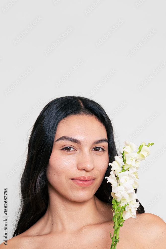 Confident Natural Woman Holding White Flowers with Minimal Background Confident Natural Woman Holding White Flowers with Minimal Background