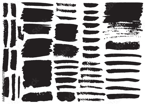Black ink brush strokes of varying sizes and textures on a white background