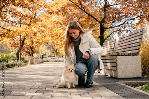 Wallpaper Mural Owner with Pomeranian dog at the city street outdoors. Torontodigital.ca