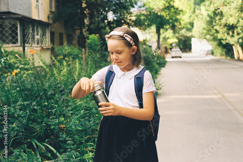 A schoolgirl on her way to school.