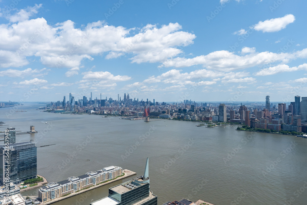 Fototapeta premium Stunning East River view of New York City skyline and iconic bridges on clear day