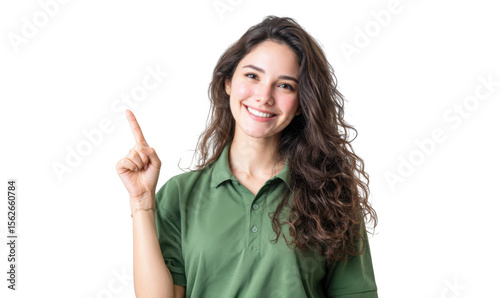 A cheerful young woman wearing a green polo shirt points to the side. showcasing a friendly demeanor in a bright. minimalist setting ideal for promotional or advertising purposes
