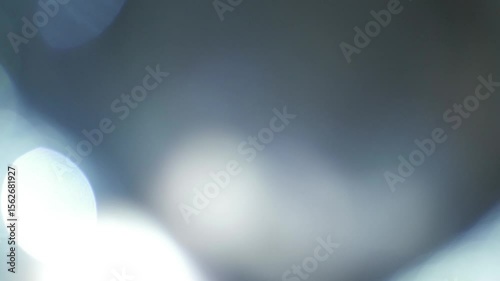A slow, ambient, and seamless loop of a luminous, organic light leak overlay, featuring soft, glowing washes of light perfect for creating a dreamy, nostalgic, or vintage atmosphere