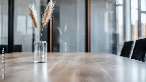 Minimalist Interior with Dried Grasses in Glass Vase on Wooden Table