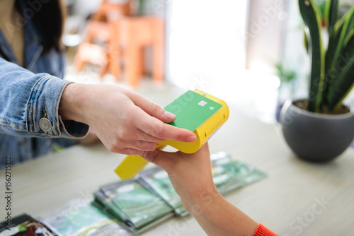 Unrecognizable customer paying with contactless credit card