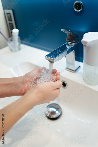 Washing Hands With Care at a Modern Bathroom Sink