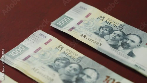 Money $1000 peso bills on a wooden table