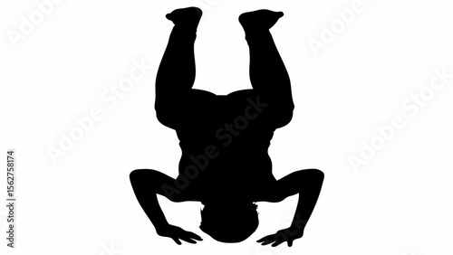 Silhouette of a person performing a headstand with legs extended upwards in a yoga or acrobatic pose