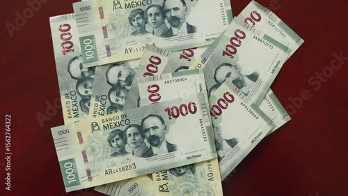 Money $1000 peso bills on a wooden table