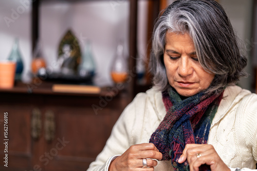Senior woman wearing knitted shawl indoors