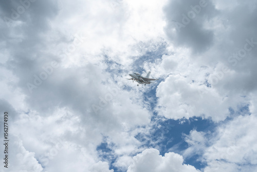 Fighter jet flies through the sky on technology background