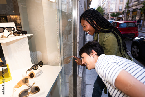 Friends Enjoying Window Shopping at Optician Store