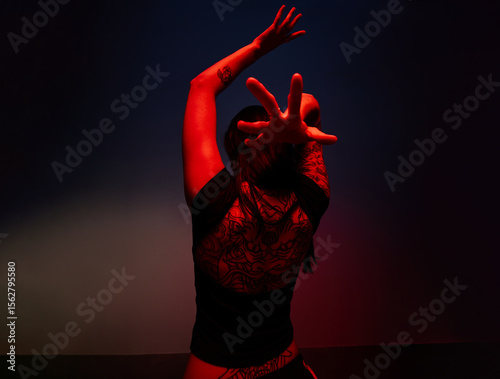 Dynamic dancer showcases expressive movement in dramatic lightin