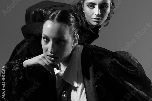 Fashion editorial with two women in bold outfits, black and white pic