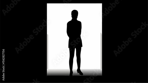 Silhouette of a person standing in front of a bright light with a dark background around the light