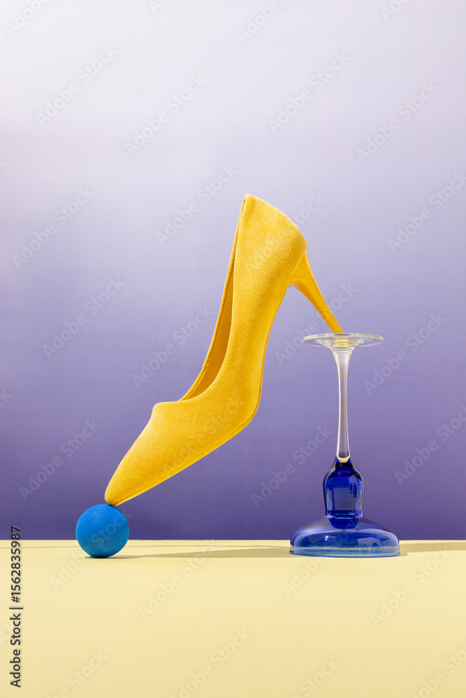 Yellow high-heel balancing on modern objects with bold colors Yellow high-heel balancing on modern objects with bold colors