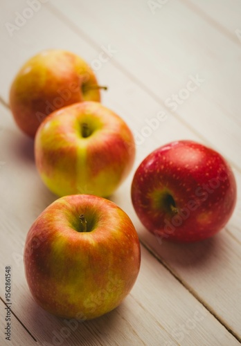Fresh red apples on wooden table