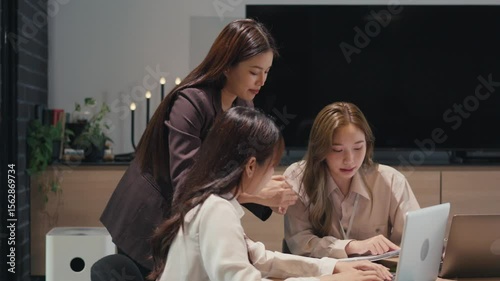 Asian office employee supervising Mentor training trainee at office
