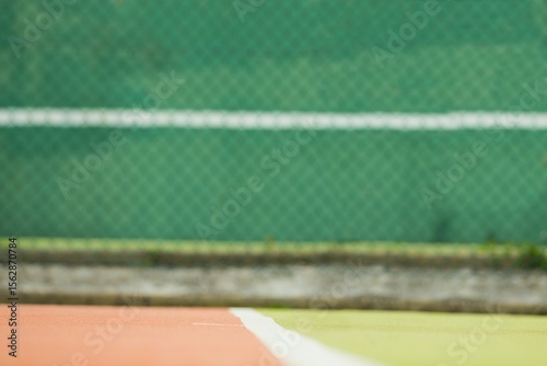 Flat design illustration is showing orange and green tennis court with white line, green fence