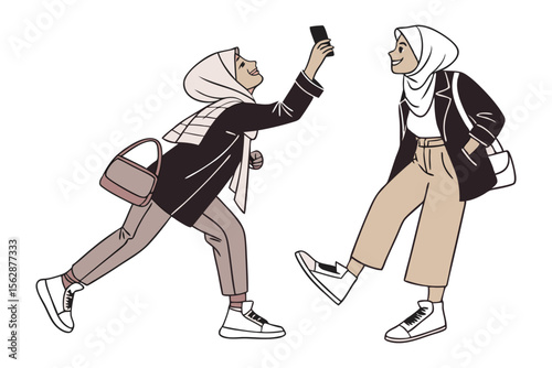 Shared Moment: Two young women, adorned in hijabs and modern attire, capture a vibrant moment through a shared selfie. Depicting the fusion of tradition with modern expression and connection.