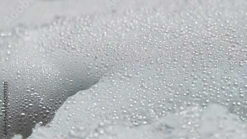 Water droplets on light gray surface
